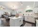 The updated kitchen has a center island, tile floors, and updated appliances at 2810 N 112Th Ln, Avondale, AZ 85392