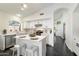 Kitchen features white cabinets, stainless appliances, and an island with seating at 2810 N 112Th Ln, Avondale, AZ 85392