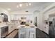 Bright kitchen featuring white cabinets, stainless appliances, and modern countertops at 2810 N 112Th Ln, Avondale, AZ 85392