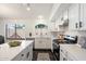 Charming kitchen with white cabinets, stainless steel appliances, and tile flooring at 2810 N 112Th Ln, Avondale, AZ 85392