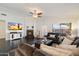 Living room features vaulted ceilings, a modern fireplace, and comfortable seating at 2810 N 112Th Ln, Avondale, AZ 85392