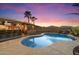 Inviting backyard pool area with a full outdoor kitchen and bar seating at 2810 N 112Th Ln, Avondale, AZ 85392