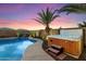Sparkling pool and spa, complete with a waterfall feature and tropical landscaping at 2810 N 112Th Ln, Avondale, AZ 85392