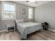 Bright bedroom with neutral walls, a cozy bed, wood-look floors, and natural light from shuttered windows at 2821 S Skyline -- # 135, Mesa, AZ 85212
