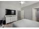 Modern bedroom with grey walls, a tv console with television and a neutral colored bed at 2821 S Skyline -- # 135, Mesa, AZ 85212