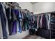 Organized closet with wood floors and hanging storage for clothing, hats, and personal items at 2821 S Skyline -- # 135, Mesa, AZ 85212