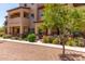 Inviting townhome featuring an arched entryway and landscaped front yard with manicured shrubs at 2821 S Skyline -- # 135, Mesa, AZ 85212