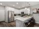 Modern kitchen featuring white cabinets, stainless steel appliances, and a stylish backsplash with bar stool seating at 2821 S Skyline -- # 135, Mesa, AZ 85212