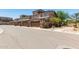 Neighborhood street view featuring stucco townhomes, private garages, and mature trees at 2821 S Skyline -- # 135, Mesa, AZ 85212