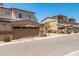 Charming townhomes featuring tan stucco, stacked stone accents, and private two-car garages at 2821 S Skyline -- # 135, Mesa, AZ 85212