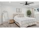 Bright bedroom with a queen bed, neutral tones, and a large window for ample natural light at 3009 E Whitton Ave, Phoenix, AZ 85016
