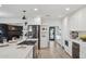 Modern kitchen featuring stainless steel appliances, a large island, and sleek white cabinetry at 3009 E Whitton Ave, Phoenix, AZ 85016