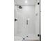 Modern shower enclosure featuring sleek subway tiles, glass doors, and contemporary fixtures at 3009 E Whitton Ave, Phoenix, AZ 85016