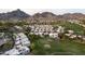 Aerial view of a residential community featuring mountains, a golf course, and mature trees at 3033 E Claremont Ave, Phoenix, AZ 85016