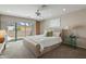 This stylish bedroom features a ceiling fan, access to the outdoor patio, and recessed lighting at 3033 E Claremont Ave, Phoenix, AZ 85016