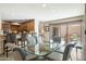 Dining area featuring a glass table with chairs, view to the kitchen, and sliding doors to the patio at 3033 E Claremont Ave, Phoenix, AZ 85016