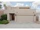 Home exterior featuring a garage, a well-kept yard, and a solid wood front door with square windows at 3033 E Claremont Ave, Phoenix, AZ 85016