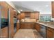Spacious kitchen featuring wood cabinetry, stainless steel appliances, and granite countertops at 3033 E Claremont Ave, Phoenix, AZ 85016