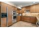 Updated kitchen featuring wood cabinets, stainless appliances, tile backsplash, and ample counter space at 3033 E Claremont Ave, Phoenix, AZ 85016