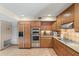 Bright kitchen showcases stainless steel appliances, wood cabinets, and tiled backsplash at 3033 E Claremont Ave, Phoenix, AZ 85016