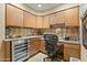 This well-lit office is equipped with custom cabinetry, granite countertops and a wine cooler at 3033 E Claremont Ave, Phoenix, AZ 85016