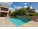 Stunning swimming pool surrounded by lush desert landscaping, featuring flower beds at 3033 E Claremont Ave, Phoenix, AZ 85016