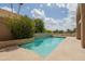 Beautiful swimming pool with desert landscaping, flower beds, and blue skies at 3033 E Claremont Ave, Phoenix, AZ 85016