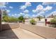 A rooftop deck with a stucco wall, palm trees, and desert landscaping and mountain views at 3033 E Claremont Ave, Phoenix, AZ 85016