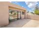 A rooftop patio with sliding glass doors, a view of palm trees, and desert landscaping at 3033 E Claremont Ave, Phoenix, AZ 85016