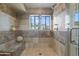 Tiled walk-in shower featuring built-in bench, rainfall showerhead and mountain views at 3033 E Claremont Ave, Phoenix, AZ 85016