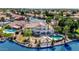 Expansive home overlooking a lake featuring a pool, patio, well-manicured landscaping, and scenic waterfront views at 3112 N 110Th Ave, Avondale, AZ 85392