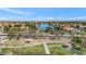 Beautiful aerial view of a lakeside community with lush green spaces and walking paths at 3112 N 110Th Ave, Avondale, AZ 85392