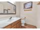 Bathroom with a wood vanity, white sink, and modern fixtures at 3112 N 110Th Ave, Avondale, AZ 85392