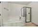 Bright bathroom featuring a soaking tub and separate glass shower at 3112 N 110Th Ave, Avondale, AZ 85392