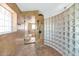 Elegant bathroom with glass enclosed shower and glass brick design, featuring tan finishes at 3112 N 110Th Ave, Avondale, AZ 85392