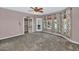 Bedroom with ceiling fan, carpeted floors, and access to the backyard at 3112 N 110Th Ave, Avondale, AZ 85392