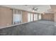 Large room featuring an accent wall, carpeted floors, and mirrored wall at 3112 N 110Th Ave, Avondale, AZ 85392