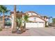 Two-story home showcasing a three-car garage, landscaped yard and a mature palm tree at 3112 N 110Th Ave, Avondale, AZ 85392