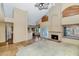 Spacious living room with a fireplace and tile flooring, offering an open view to the kitchen and backyard at 3112 N 110Th Ave, Avondale, AZ 85392