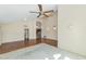 Open-concept living room featuring vaulted ceilings, a combination of carpet and hardwood, with neutral-toned walls at 3112 N 110Th Ave, Avondale, AZ 85392