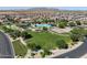 An aerial view of the community park with pool, playground, picnic tables, and open green space at 323 S San Fernando Ln, Casa Grande, AZ 85194