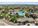 An aerial view showcases the community pool, playground and park amenities in the surrounding neighborhood at 323 S San Fernando Ln, Casa Grande, AZ 85194