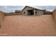 Expansive dirt backyard, enclosed by a privacy wall, awaits landscaping and personalization at 323 S San Fernando Ln, Casa Grande, AZ 85194