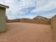 An expansive, undeveloped backyard with block fencing provides a blank canvas for landscaping and recreation at 323 S San Fernando Ln, Casa Grande, AZ 85194