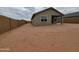 A spacious, undeveloped backyard with tan perimeter walls offers privacy and customization opportunities at 323 S San Fernando Ln, Casa Grande, AZ 85194