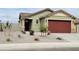 Charming single-story home featuring a two-car garage, landscaped front yard, and a welcoming entrance at 323 S San Fernando Ln, Casa Grande, AZ 85194