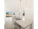 Open-concept kitchen featuring an island, modern lighting, and sliding glass doors to the backyard at 323 S San Fernando Ln, Casa Grande, AZ 85194
