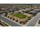 High aerial view of a planned community featuring green spaces, desert landscaping, and well-maintained streets at 3247 N Loma Vis, Mesa, AZ 85213