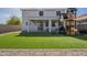 Spacious backyard features a playset, synthetic lawn, and a covered patio at 3247 N Loma Vis, Mesa, AZ 85213