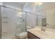 Bathroom featuring a glass-enclosed shower, white fixtures, and a wooden vanity at 3247 N Loma Vis, Mesa, AZ 85213
